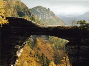 Natural stone bridge in the mountains with mountains in the background 
