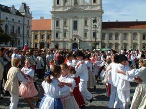 Traditionally clothed people dancing on town square