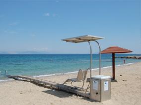 Greek beach with sunbeds and umbrellas