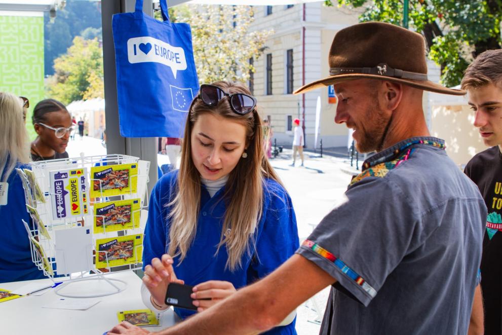 Hostess helping visitors with their smartphone