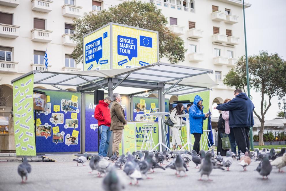 Tour booth with a flock of pigeons at the front