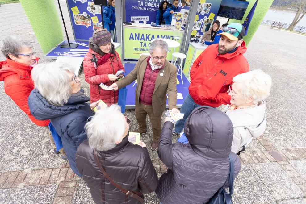 A man distributing promotional material to a group of people