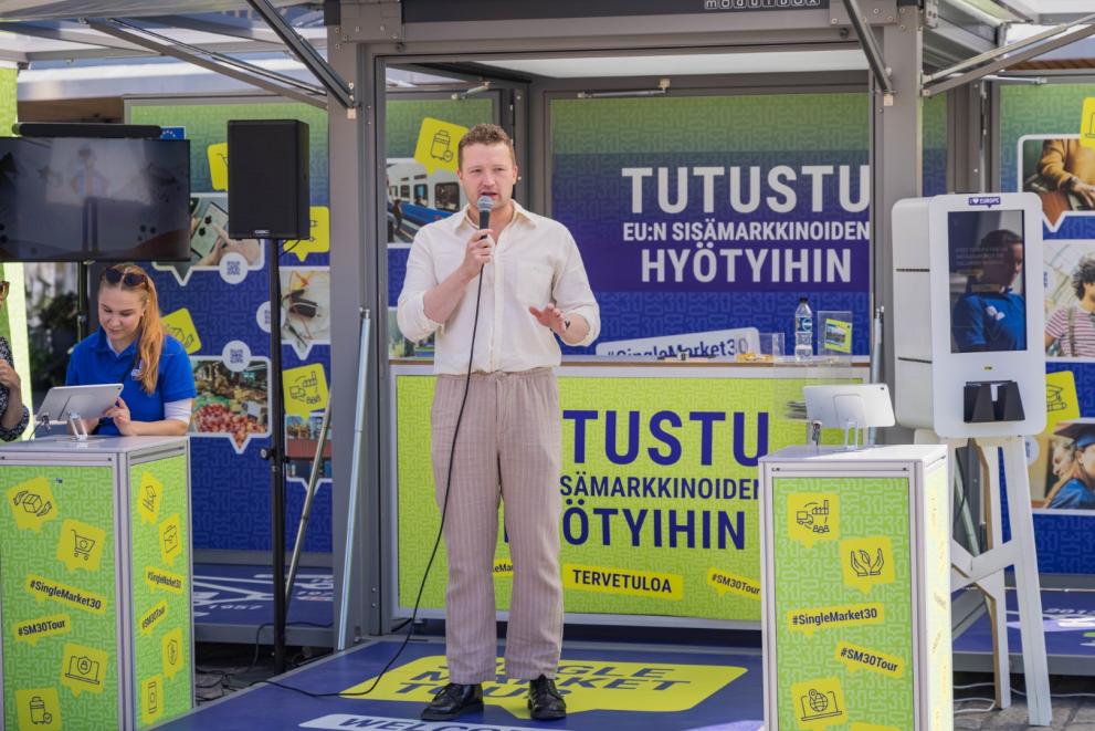Man giving a speech at the Tour booth