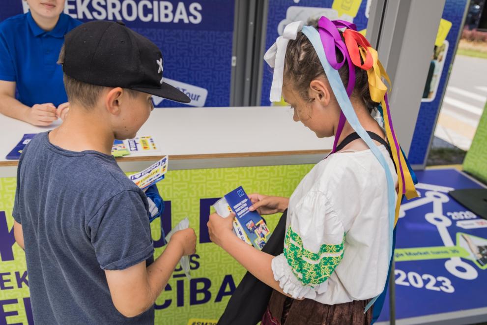 Two kids looking at their promotional materials