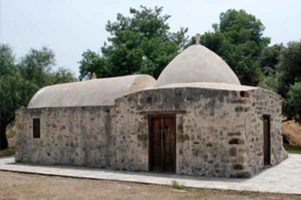 Traditional stone house with dome and trees in the background